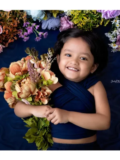 That radiant smile can light up any room. This is from a fourth birthday milestone session, with the birthday girl surrounded by a beautiful floral arrangement.