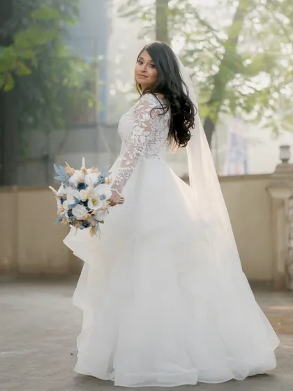 A graceful portrait of the bride, her veil adding a touch of drama.
