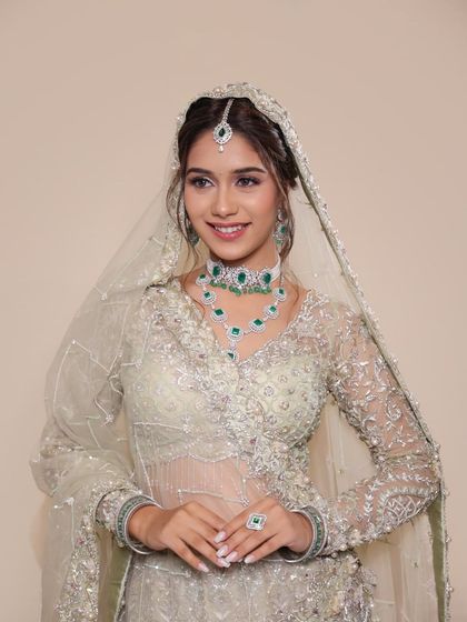 A full-length view of the model in a beautiful pastel green lehenga, showcasing the kind of complete bridal look taught in my course.