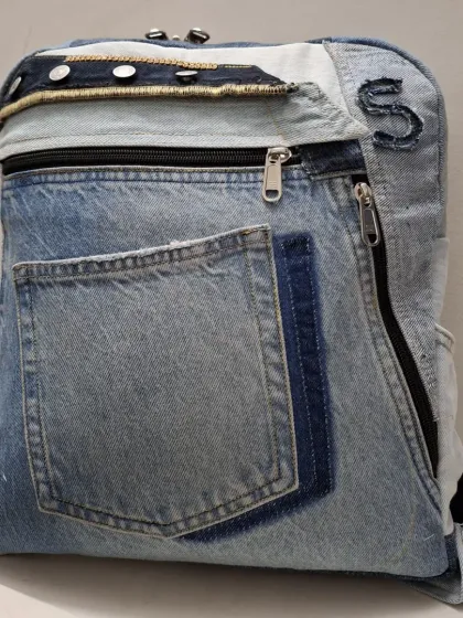 Another view of a custom backpack made from recycled denim. Notice how I use different shades of denim and original pockets to create a unique, textured look.