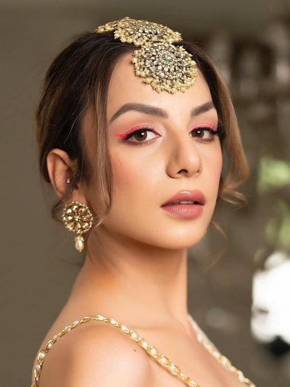 A pop of neon pink eyeliner is a fun and modern way to add color to your look. Paired with a nude lip and soft skin, it makes a bold yet chic statement.