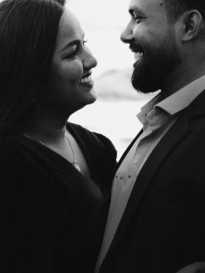 A close-up black and white shot filled with genuine laughter and joy. This image perfectly captures the happiness and chemistry between the couple.