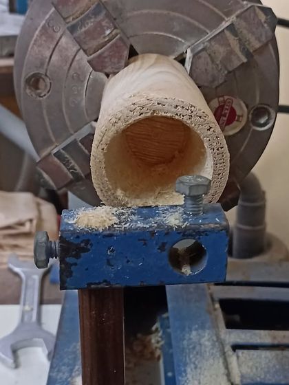 The inside of the cup holder after being hollowed out on the lathe. The rough texture is from the initial drilling, which is then smoothed out.