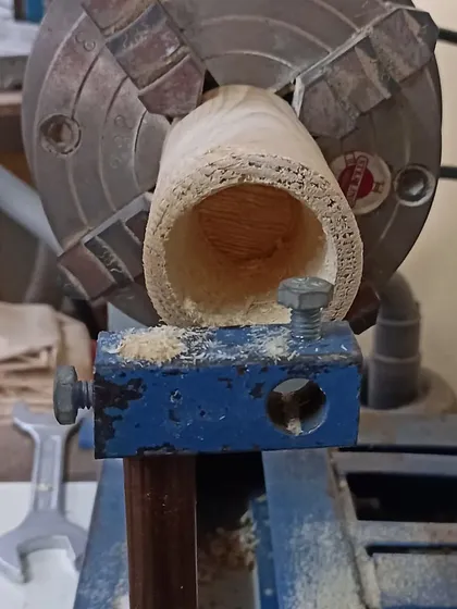 The inside of the cup holder after being hollowed out on the lathe. The rough texture is from the initial drilling, which is then smoothed out.