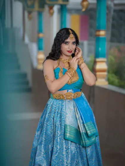 A stunning blue half-saree look from a student's portfolio day. The makeup is glamorous with a bold red lip.