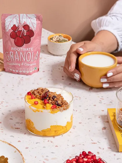 A bright and inviting breakfast scene styled for Rootivate's granola. I used natural light, fresh ingredients like mango and pomegranate, and warm ceramic tones to create a wholesome and aspirational morning moment.