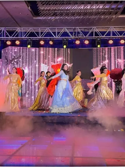 The bride's performance, elevated by dancers with colorful props and a mystical smoke effect on an LED dance floor.