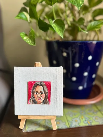 My mini portrait of Gurjit displayed on an easel.