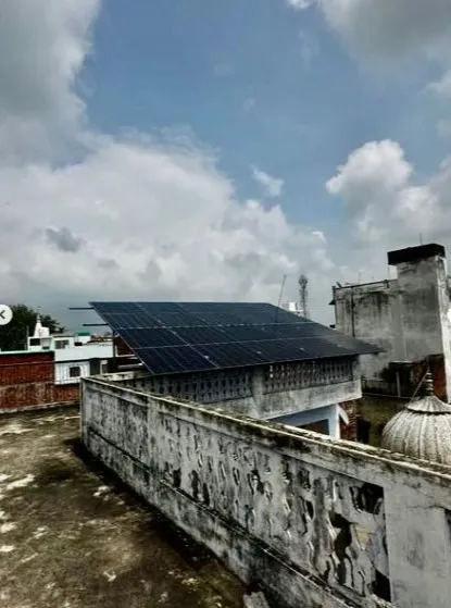 A rooftop solar panel array installed in Jalalpur, Uttar Pradesh. This 5kW system is designed to capture maximum sunlight, providing clean energy for the home and charging the battery for backup.