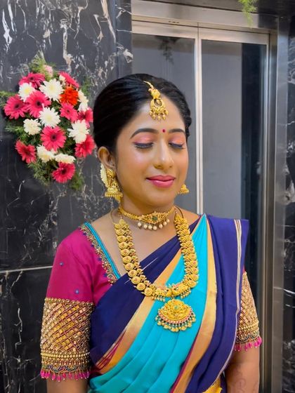 A close-up of Kavya's makeup, with soft pink eyeshadow and a matching lip.