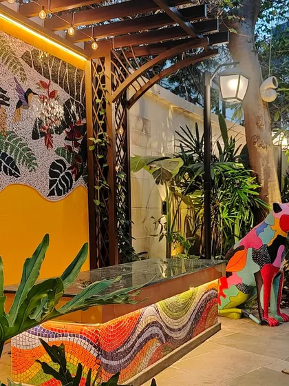 We believe outdoor spaces should be as artistic as they are green. For this backyard, we designed and installed a vibrant, handcrafted mosaic wall and bench, complemented by a bold panther sculpture, turning the area into a unique gallery of outdoor art.
