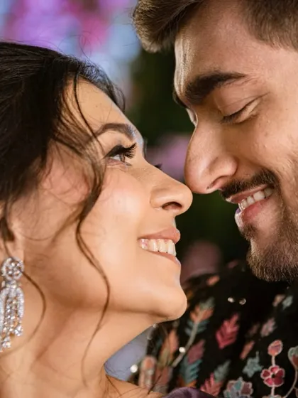 An intimate couple moment that captures the joy of the sangeet night. The bride's makeup looks flawless even up close.