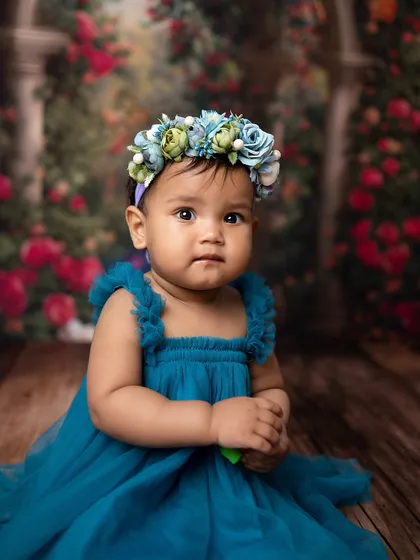 A sweet close-up portrait after her tub time fun. Her curious expression and beautiful outfit make for a stunning photo.