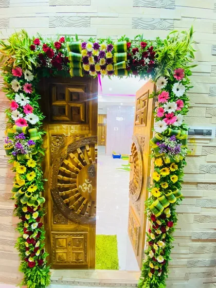 The celebration begins at the front door. Here is an example of a lush floral arch I designed for a home entrance, using a mix of fresh greenery and colorful flowers to welcome guests and Bappa into the home.