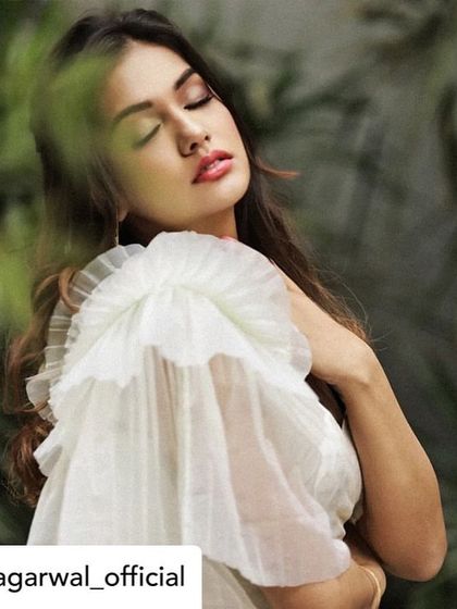 A close-up of Divya Agarwal wearing our signature ruffled sleeve blouse. The soft, layered tulle creates a beautiful texture and movement, showcasing our love for dramatic and feminine details.