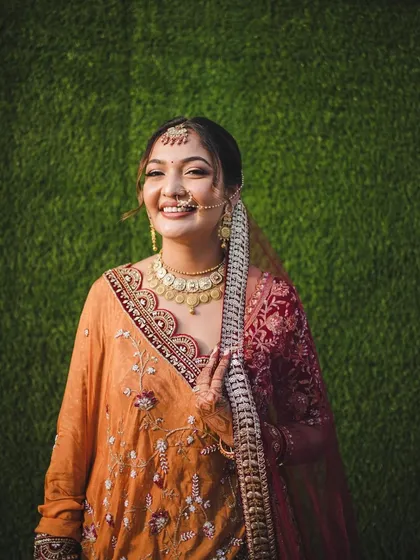 A happy, candid shot. The soft updo keeps the hair off her face, letting her radiant smile and glowing skin take center stage.