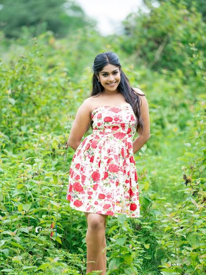 A sweet and summery look with a floral dress in a field of green. This outdoor shot feels fresh, natural, and full of life.