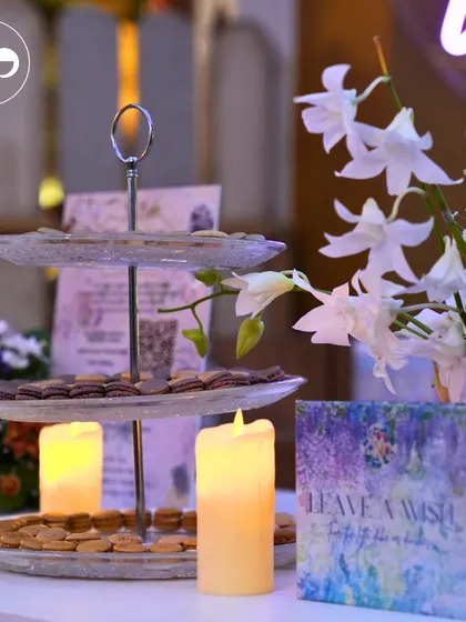 A sophisticated dessert table with a tiered stand and glowing candles. This setup was part of a chic, Bridgerton-inspired baby shower, blending elegance with sweet indulgence.