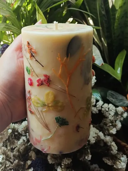 A closer look at one of our large floral love pillar candles. Each one is handcrafted with real pressed flowers, making every candle a unique piece of botanical art.