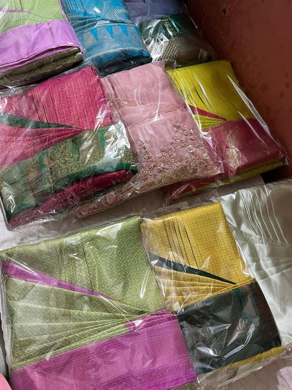 A large batch of sarees, all packed and ready for delivery. This is a common sight here.