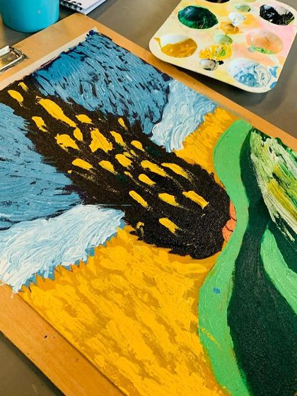 A close-up of a painting in progress, showing the thick application of paint (impasto) to mimic Van Gogh's style.