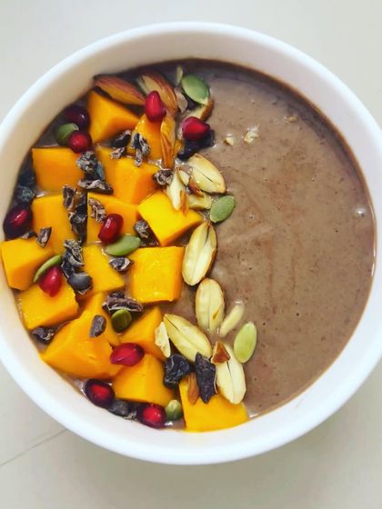 This sumptuous Choco Banana Smoothie is packed with the goodness of banana, dates, mango, and cacao. Topped with nuts and cacao nibs, it's an instant mood and energy booster.