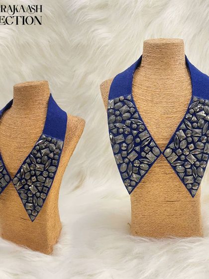 This royal blue detachable collar is densely packed with faceted gunmetal-grey stones. The texture and sparkle of the stones create a modern, edgy look perfect for evening wear.