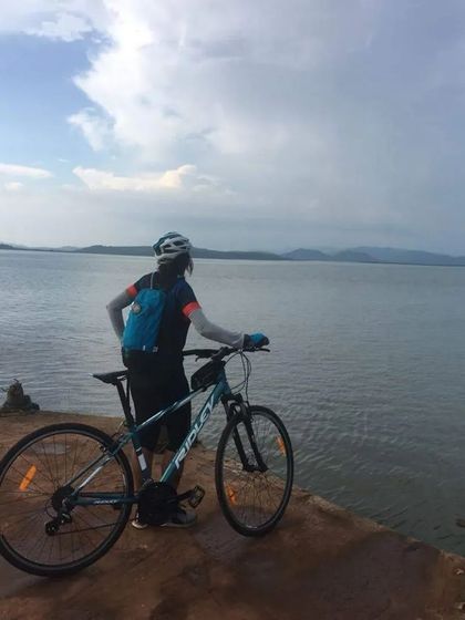 A rider looks out over the vast Aghanashini river estuary. Our Gokarna tour offers unforgettable views of the Arabian Sea and the mighty rivers that flow into it.