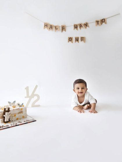 A sweet and simple shot of the baby crawling with a big smile, celebrating being halfway to one.