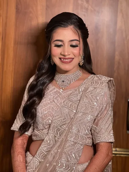 A serene portrait with eyes closed, highlighting the soft glam eye makeup.