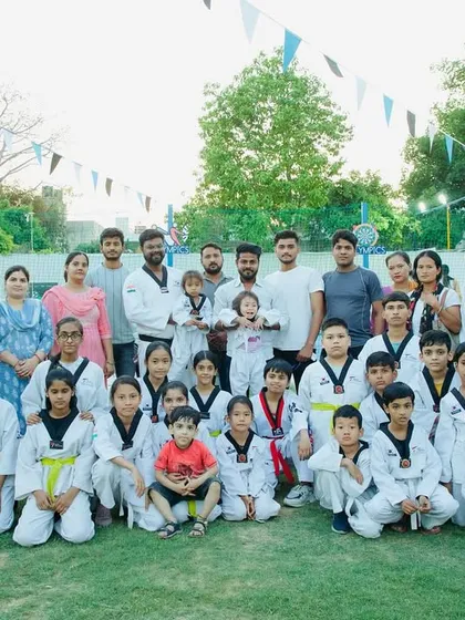 The entire Aarav family. A group photo with students, parents, and coaches, celebrating together. This is the community that supports our champions.
