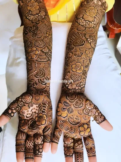 This design for bride Naziya from Mumbai is filled with a variety of elements, including roses, hearts, and geometric patterns, creating a rich and full bridal look.