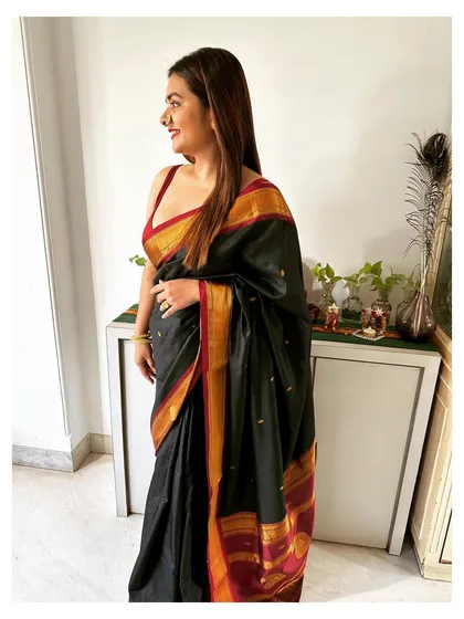 A rare moment of being wedding-ready myself. Dressed in a classic black saree with a red and gold border, embracing my own Marathi mulgi roots.