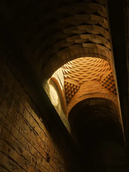 Another perspective of the brick dome, showing how the light from the oculus washes over the textured surfaces. The mathematical beauty of the structure creates a sense of rhythm and harmony.