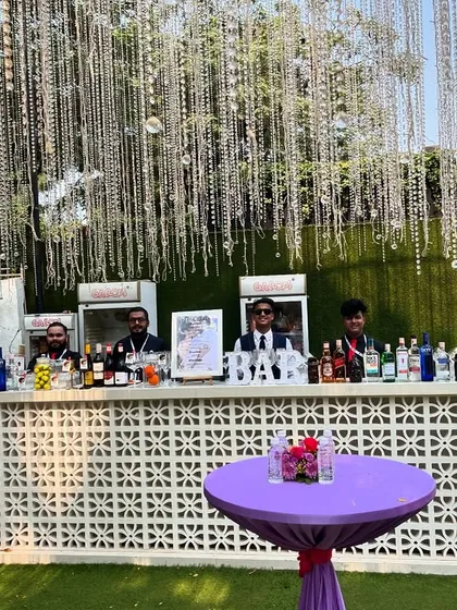 A wide shot of our bar at the Mahalaxmi Race Course. The purple cocktail tables complement the decor, showing our attention to detail.
