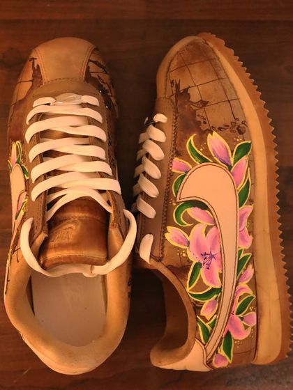 An overhead view of the floral world map Nike Cortez. This angle shows how the design flows around the entire shoe, creating a cohesive and beautiful piece of art.
