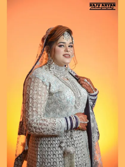 A three-quarter portrait of the Muslim bride. This shot beautifully displays the detailed craftsmanship of her necklace, dress, and the traditional kalire.