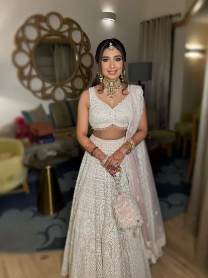 Reimagining the modern Indian princess. Vasvi's stunning features shine with a winged liner for regal eyes and soft pink hues on her cheeks and lips.