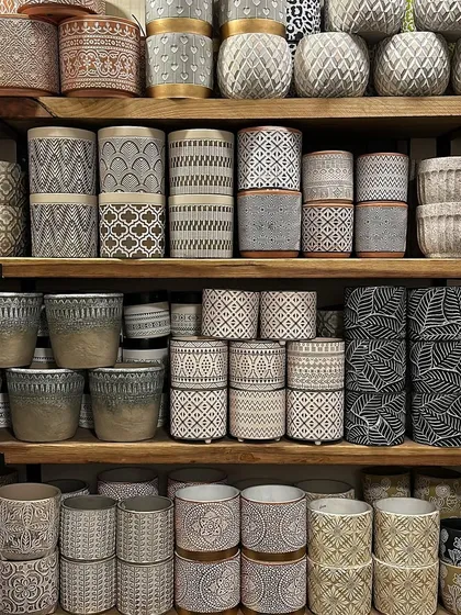 I love this shelf display. It shows the variety of gorgeous planters I have for both indoor and outdoor use, with a focus on pots that feature pops of color, texture, and geometric patterns.