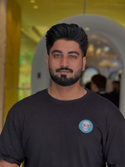 A frontal view of a modern men's haircut. The style is both trendy and professional, perfect for any occasion.