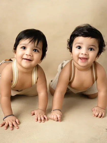 The most adorable twin brothers ever. At eight months old, their smiles are infectious, and capturing them together shows their developing bond.