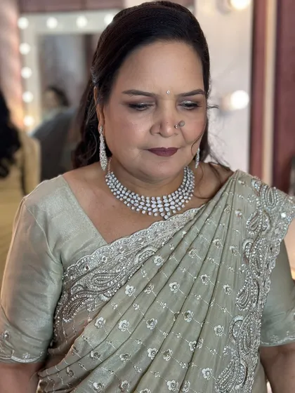 A close-up of the makeup for the mother of the bride, featuring soft, defined eyes and a flattering lip color.