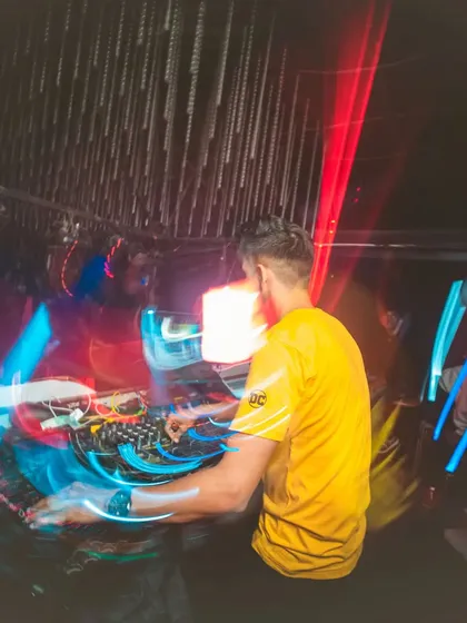 A long-exposure shot capturing the fluid motion of DJing.