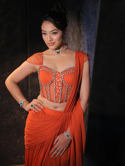 This vibrant orange concept saree features a stunningly detailed corset blouse. I designed it for a client who wanted a bold, modern, and unforgettable look for a cocktail event.