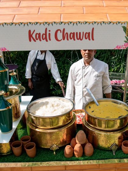 A traditional Kadhi Chawal station set up on a rustic thela cart. Served in authentic clay pots (kulhads), this dish offers a comforting and classic taste of India.