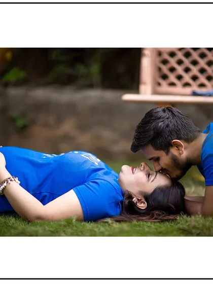 A playful and intimate pose, with the couple lying on the grass. This shows the fun and relaxed side of your relationship.