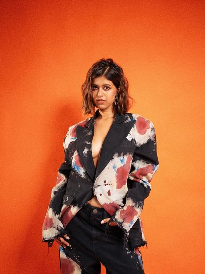 A strong and direct fashion portrait. Sejal's confident gaze and the artistic suit create a compelling image that balances personality with high-fashion aesthetics.