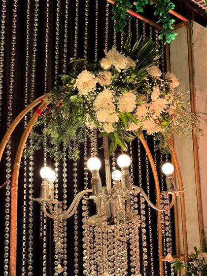 Another view of the chandelier and floral detail, showcasing the craftsmanship and the beautiful interplay of light and nature.