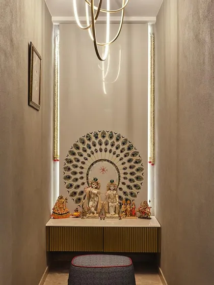 We designed this compact mandir in a cozy alcove, using warm lighting and a beautiful peacock-feather-inspired backdrop for the deities. The space feels intimate, warm, and deeply spiritual.