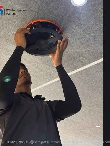 Precision is key for perfect audio. Here, one of our engineers is carefully installing a high-performance in-ceiling speaker, ensuring it is placed optimally for balanced and immersive sound distribution within the home theater.